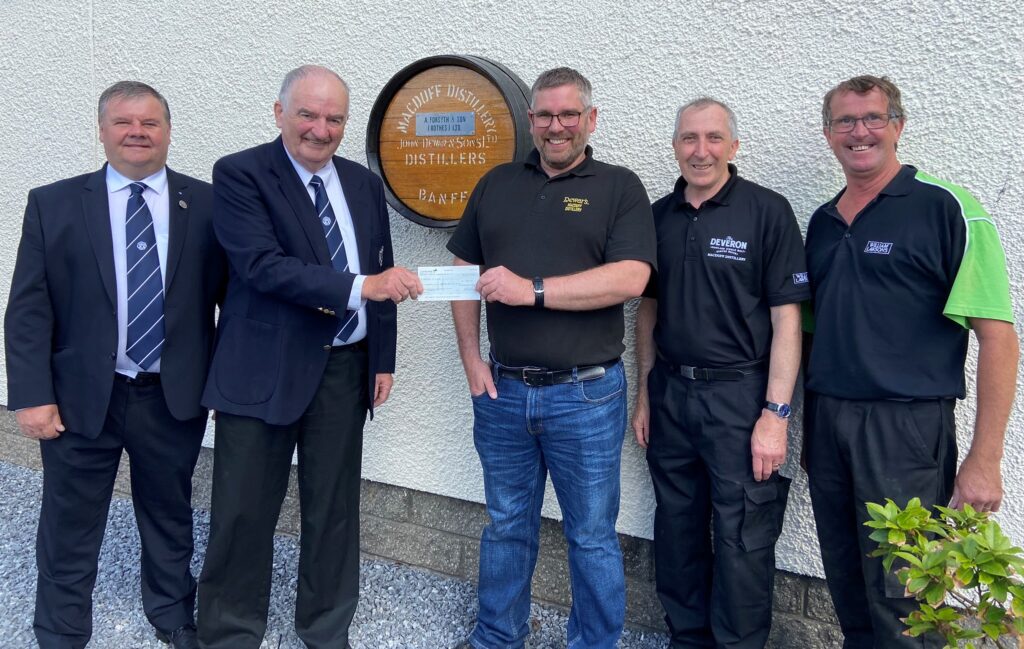 PHOTO Portsoy 75 Club Chairman Brian Sutherland accepts cheque from Macduff Distillery Manager Jamie Winfield
